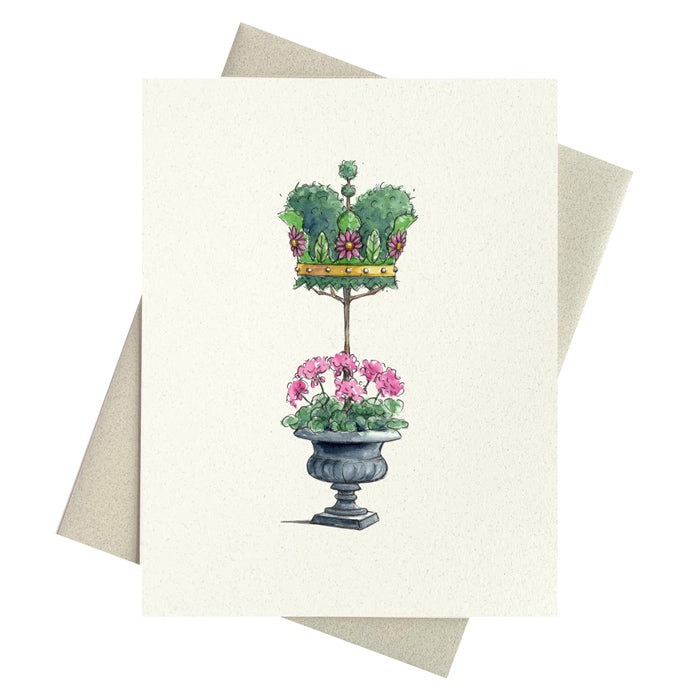 Beautiful Crown shaped topiary growing out of urn full of pink geraniums.