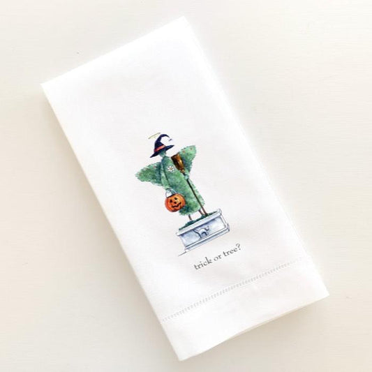 Topiary garden angel with witch's hat and broom holding trick or treat bucket printed on linen guest towel.
