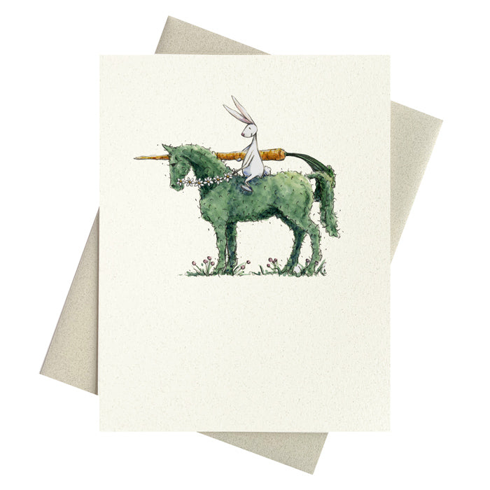 Hopefully bunny sitting astride a topiary horse while holding a carrot lance printed on a blank notecard.