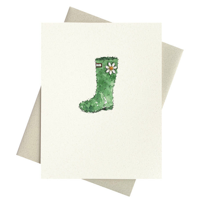Garden wellie shaped from a shrub with daisy adornment.