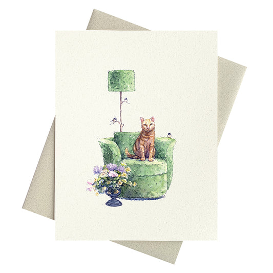 Greeting card with a ginger cat on a green chair and flowers, with a matching envelope.